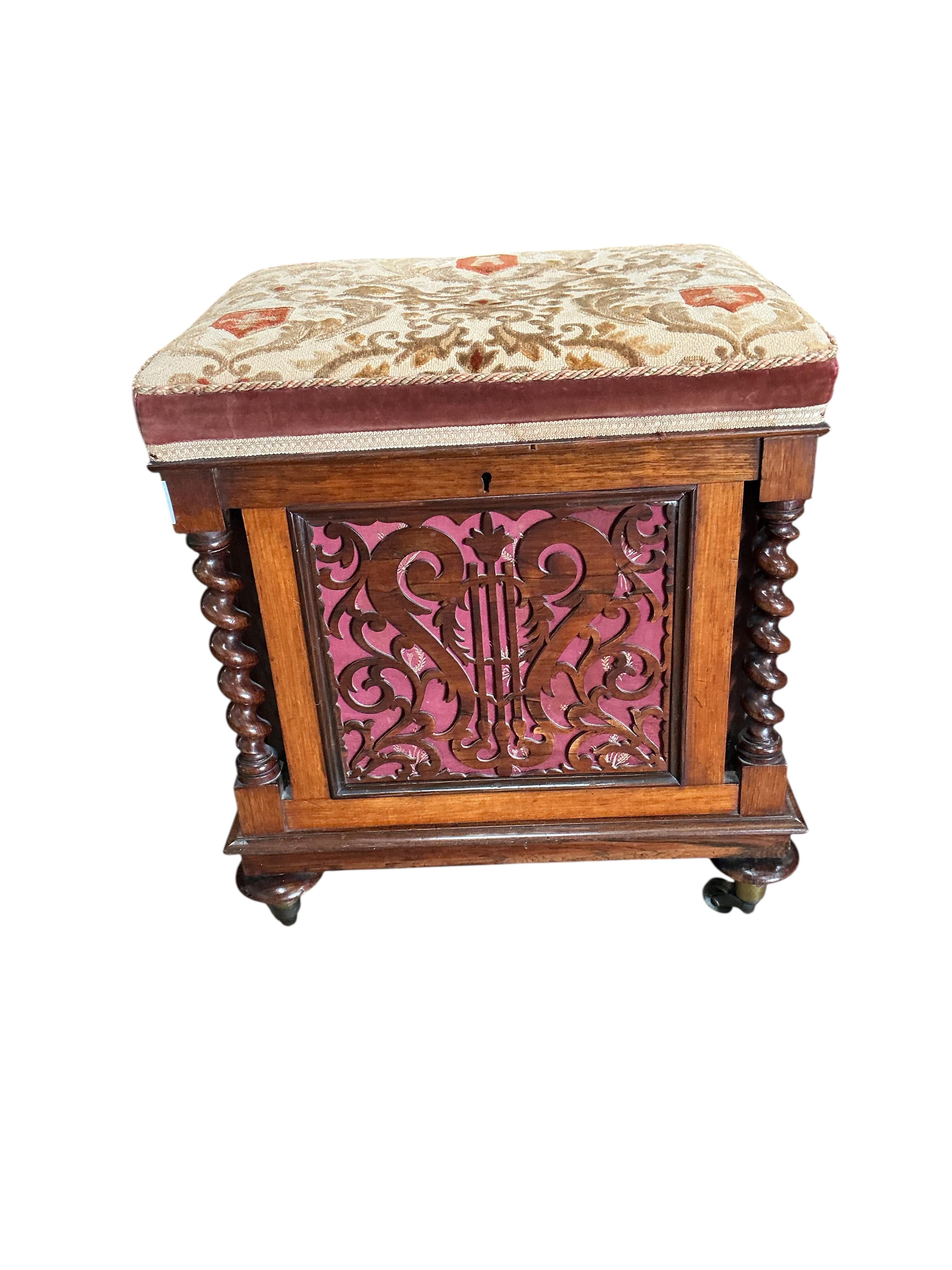 A Victorian rosewood upholstered box seat music stool with fret cut panels, width 47cm, depth 38cm, height 52cm